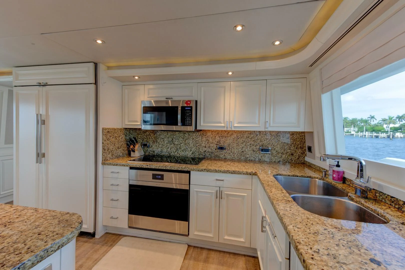 a kitchen with white cabinets aboard LIBERTAS Yacht for Sale
