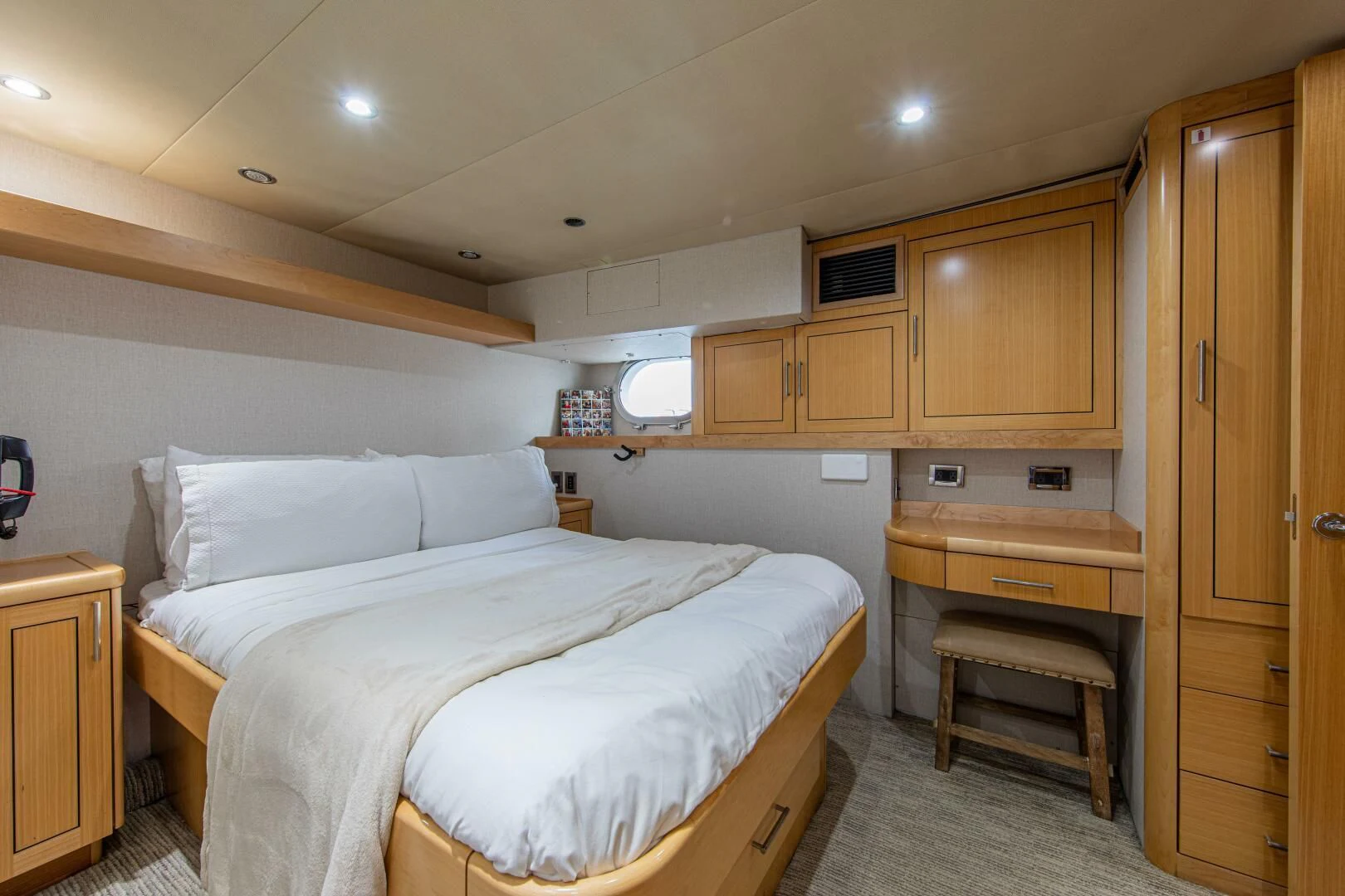 a bedroom with a bed and cabinets aboard LIBERTAS Yacht for Sale