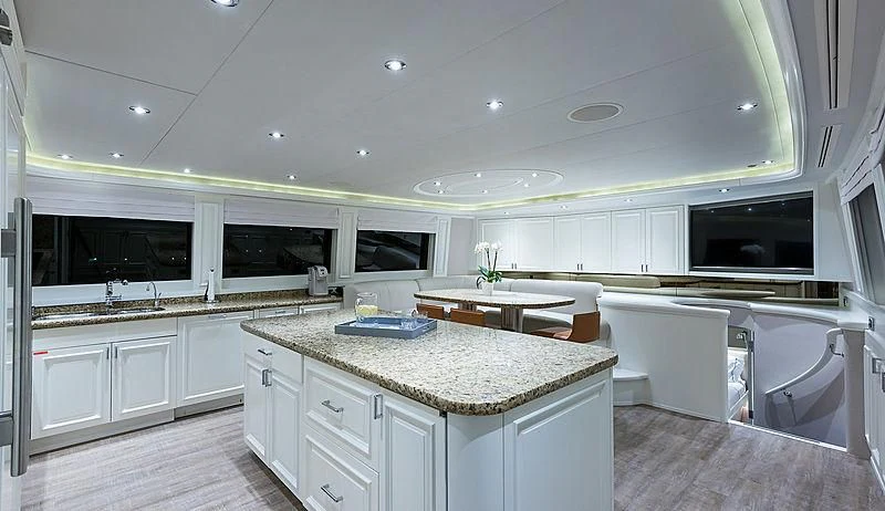 a large kitchen with white cabinets aboard LIBERTAS Yacht for Sale