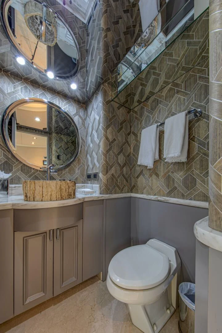 a bathroom with a toilet and a mirror aboard LIBERTAS Yacht for Sale