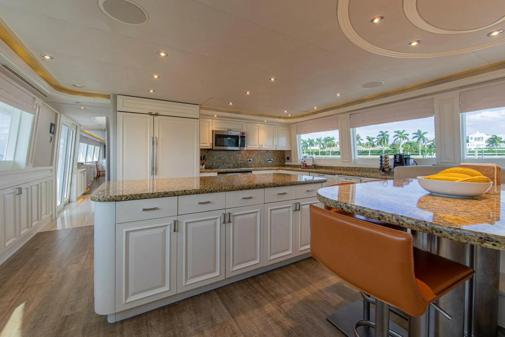 a kitchen with white cabinets aboard LIBERTAS Yacht for Sale