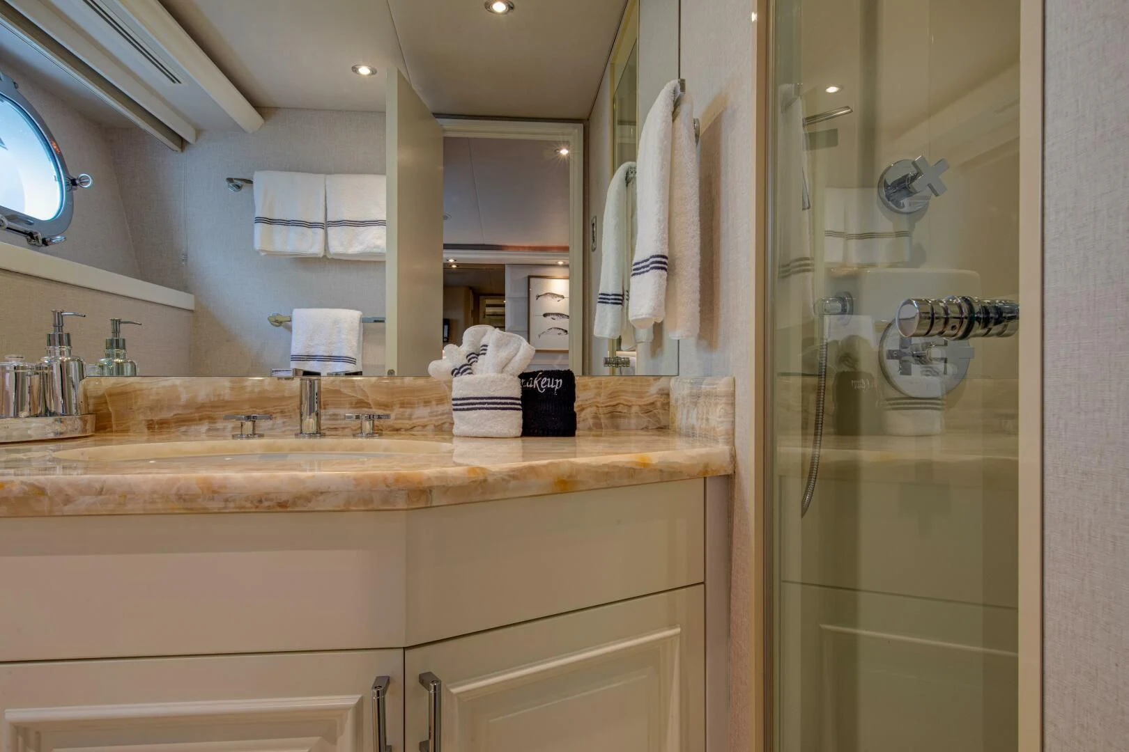a bathroom with a sink and a mirror aboard LIBERTAS Yacht for Sale