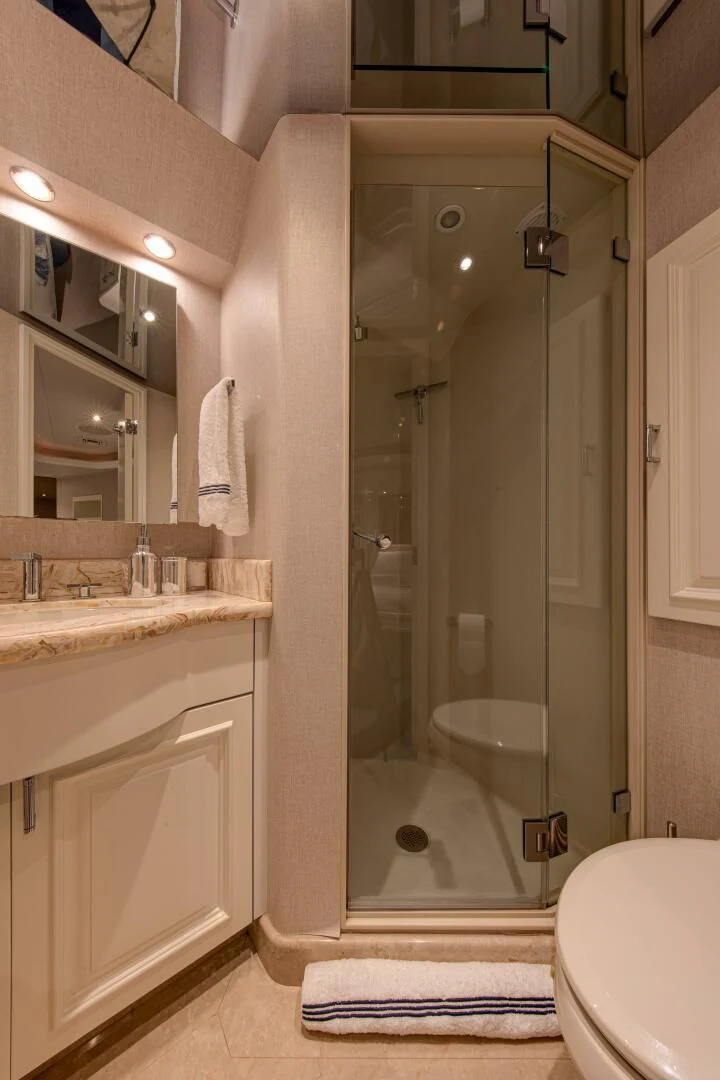 a bathroom with a glass shower aboard LIBERTAS Yacht for Sale