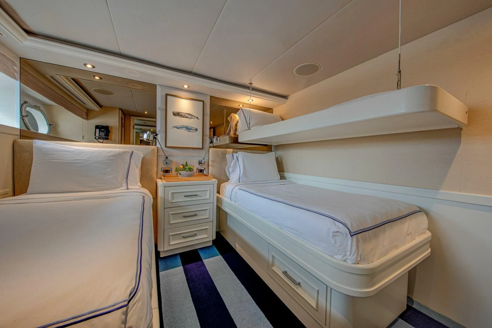a room with beds and a mirror aboard LIBERTAS Yacht for Sale