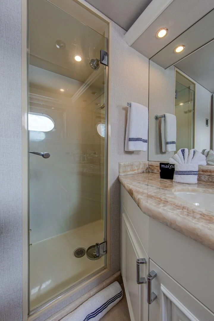 a bathroom with a shower and sink aboard LIBERTAS Yacht for Sale