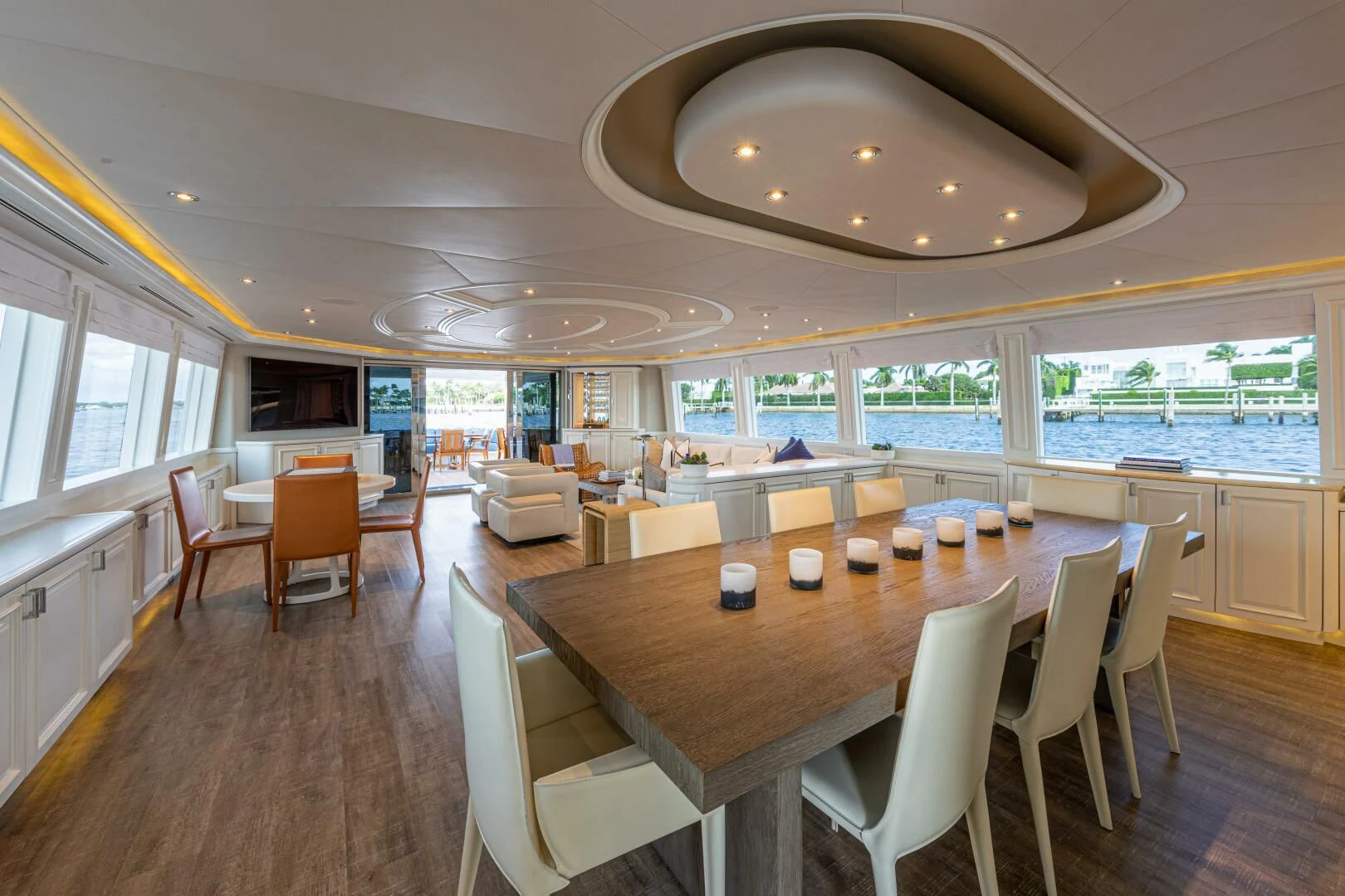 a large room with tables and chairs aboard LIBERTAS Yacht for Sale