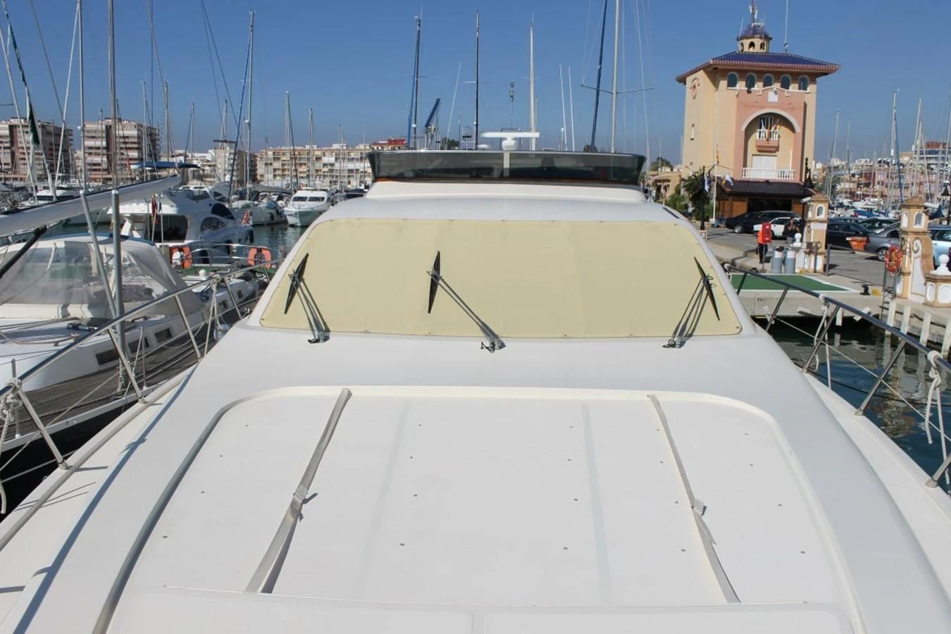 a large white boat in a harbor aboard MACAMI Yacht for Sale