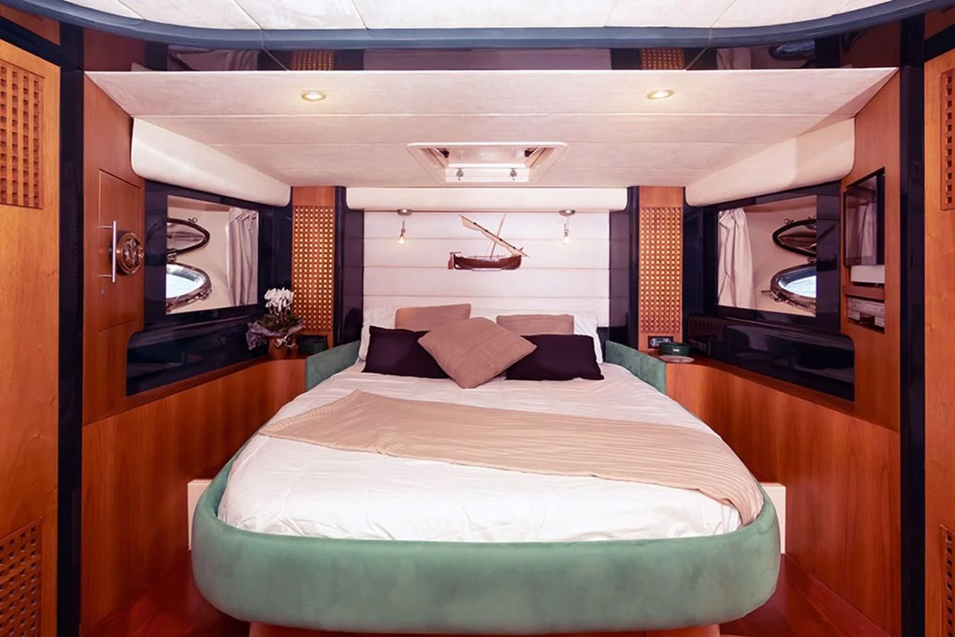 a bedroom with a bed and a mirror aboard MACAMI Yacht for Sale