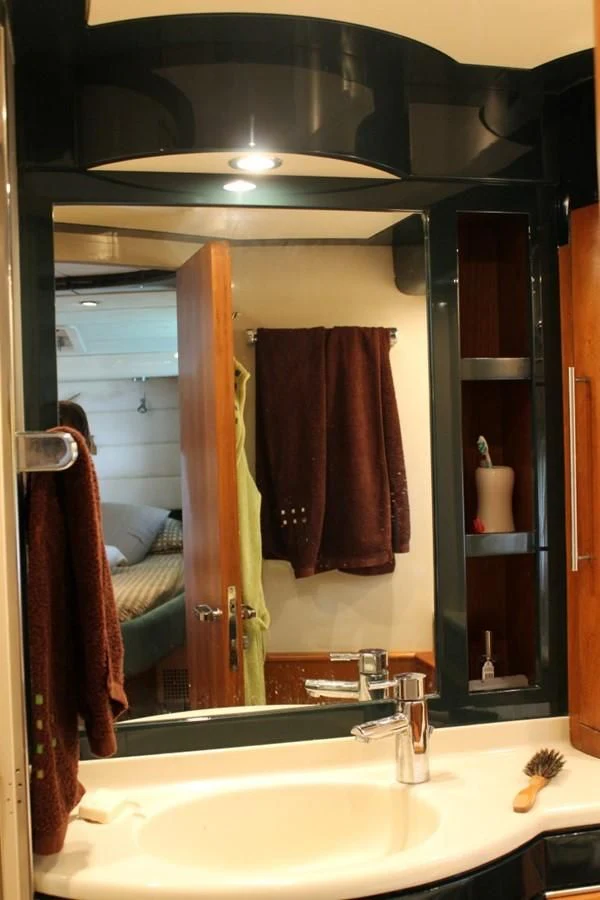 a bathroom with a large mirror aboard MACAMI Yacht for Sale
