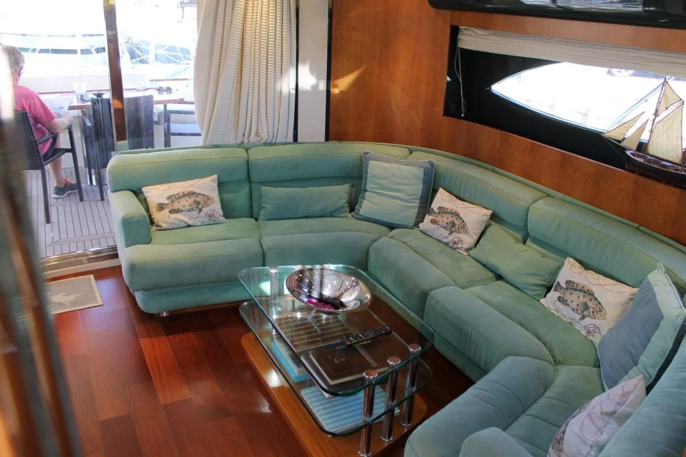 a living room with a green couch aboard MACAMI Yacht for Sale