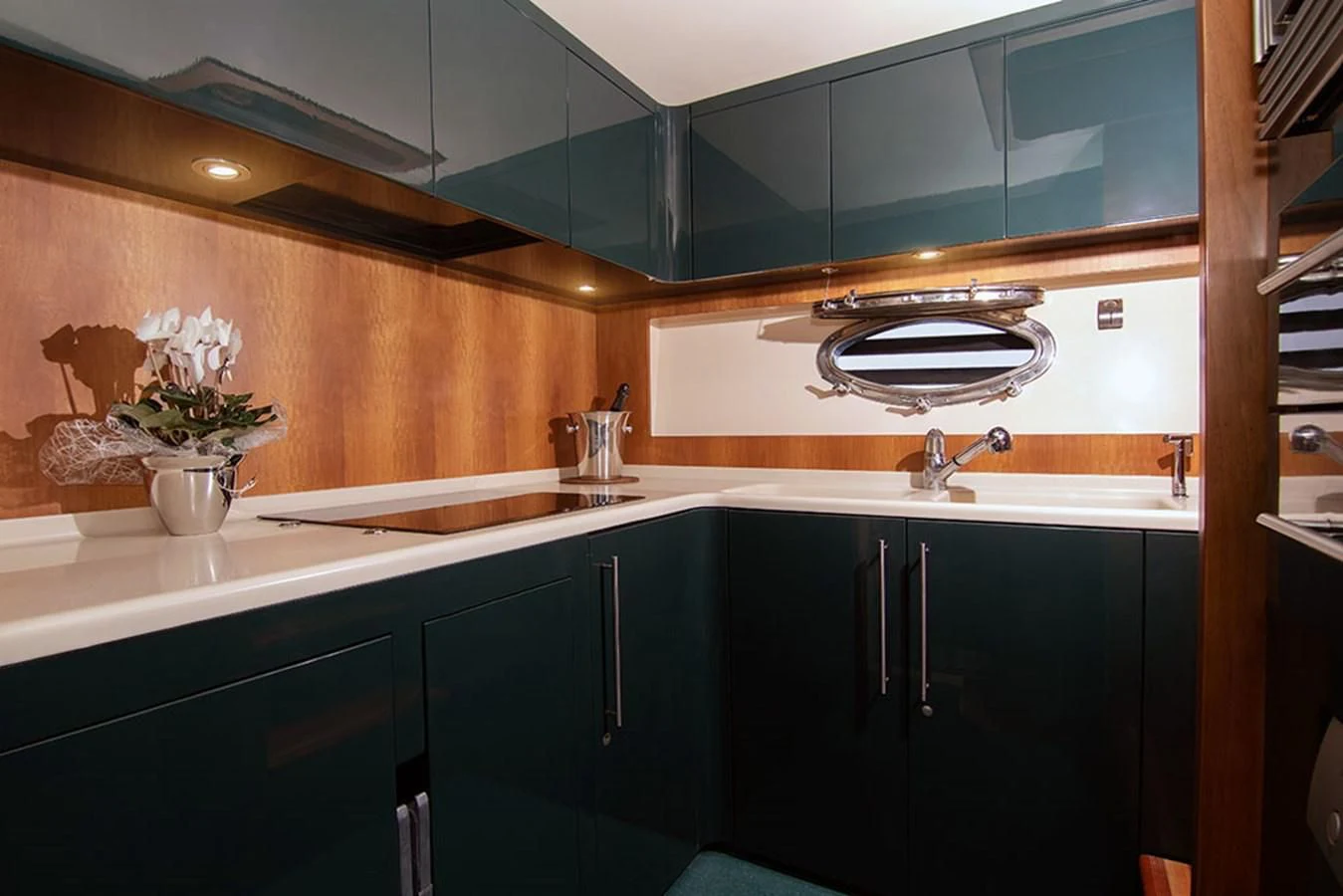 a kitchen with black cabinets aboard MACAMI Yacht for Sale