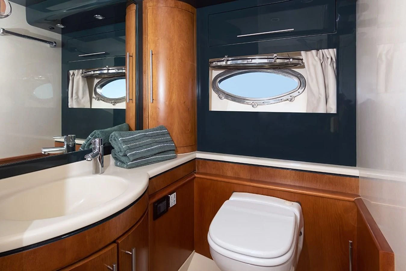 a bathroom with a mirror and a sink aboard MACAMI Yacht for Sale