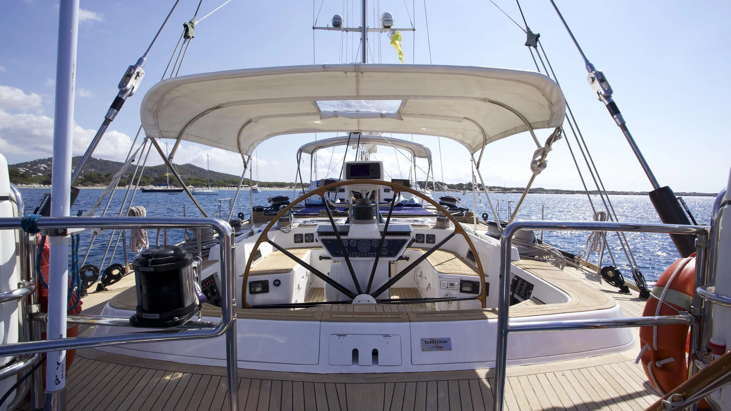 a white boat on a deck aboard EL BAILE Yacht for Sale