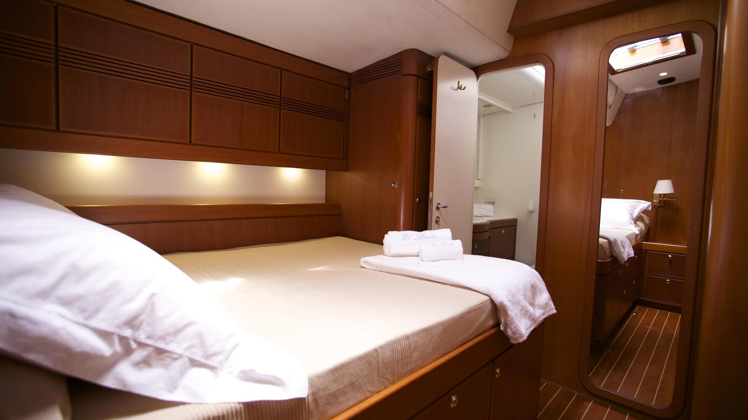 a room with a bed and a mirror aboard EL BAILE Yacht for Sale