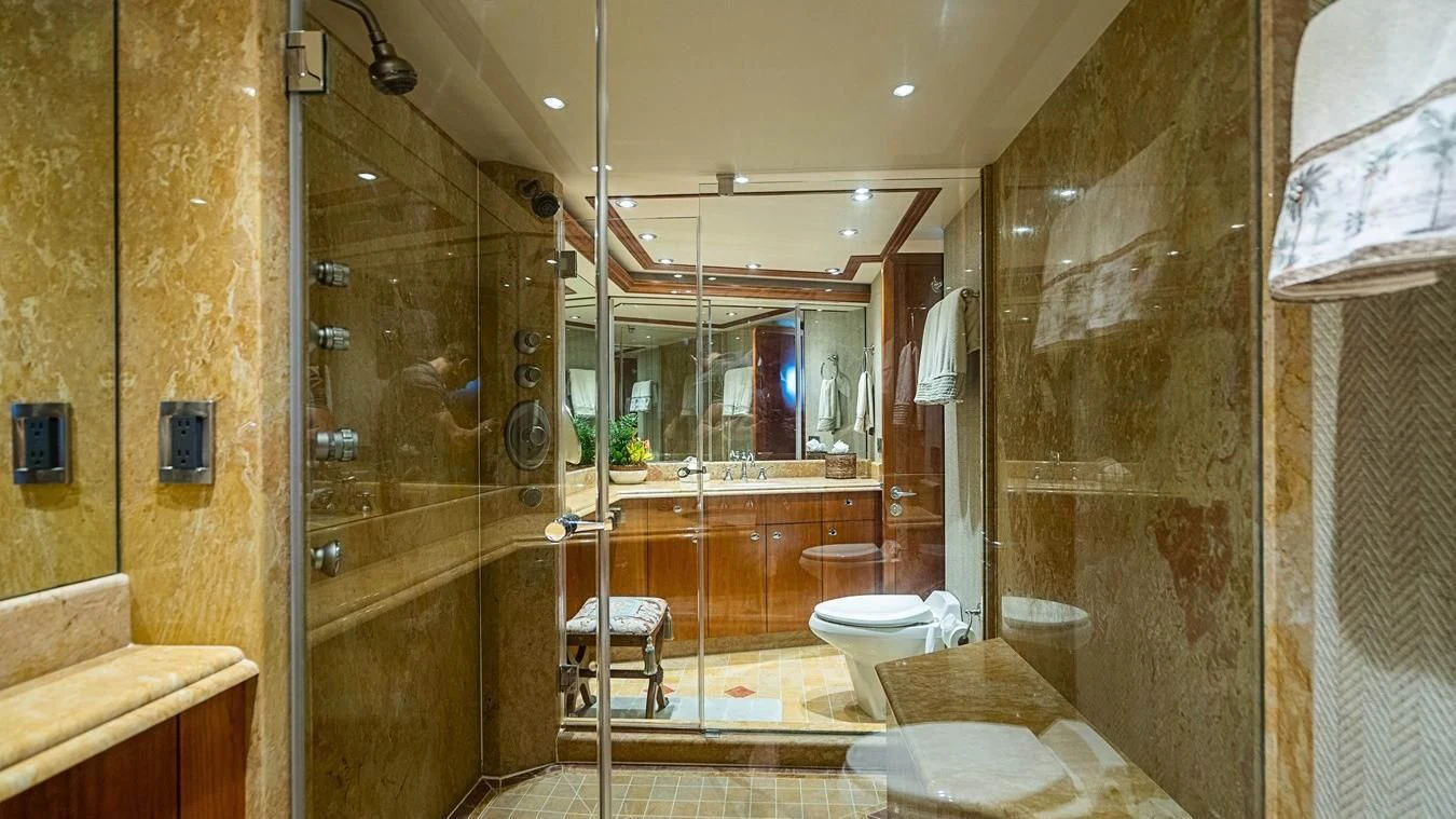 a bathroom with a glass shower aboard KEMOSABE Yacht for Charter