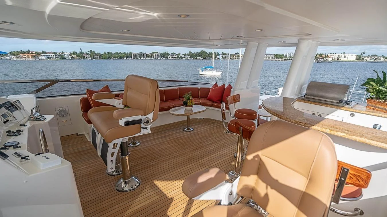 a room with a table chairs and a large body of water aboard KEMOSABE Yacht for Charter