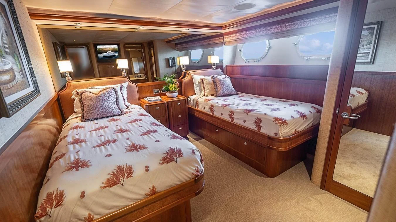 a couple of beds in a hotel room aboard KEMOSABE Yacht for Charter