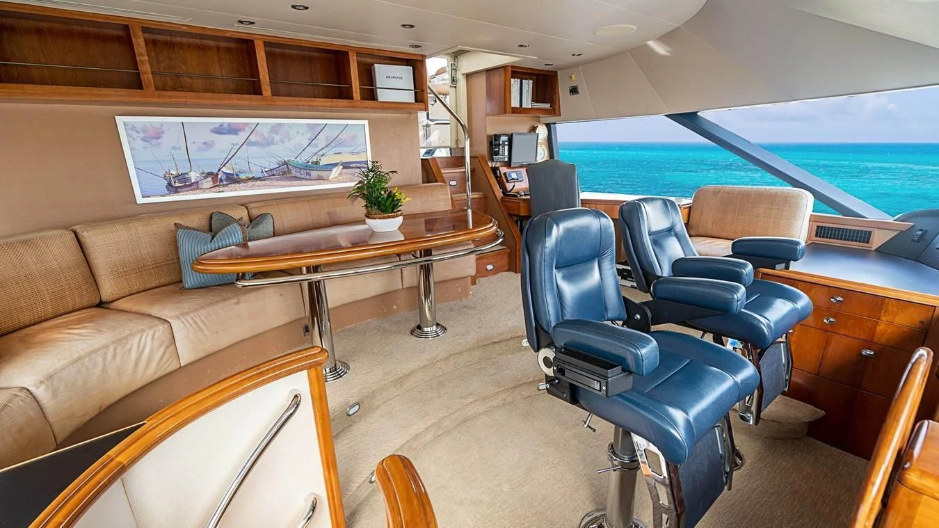a room with a table and chairs aboard KEMOSABE Yacht for Charter