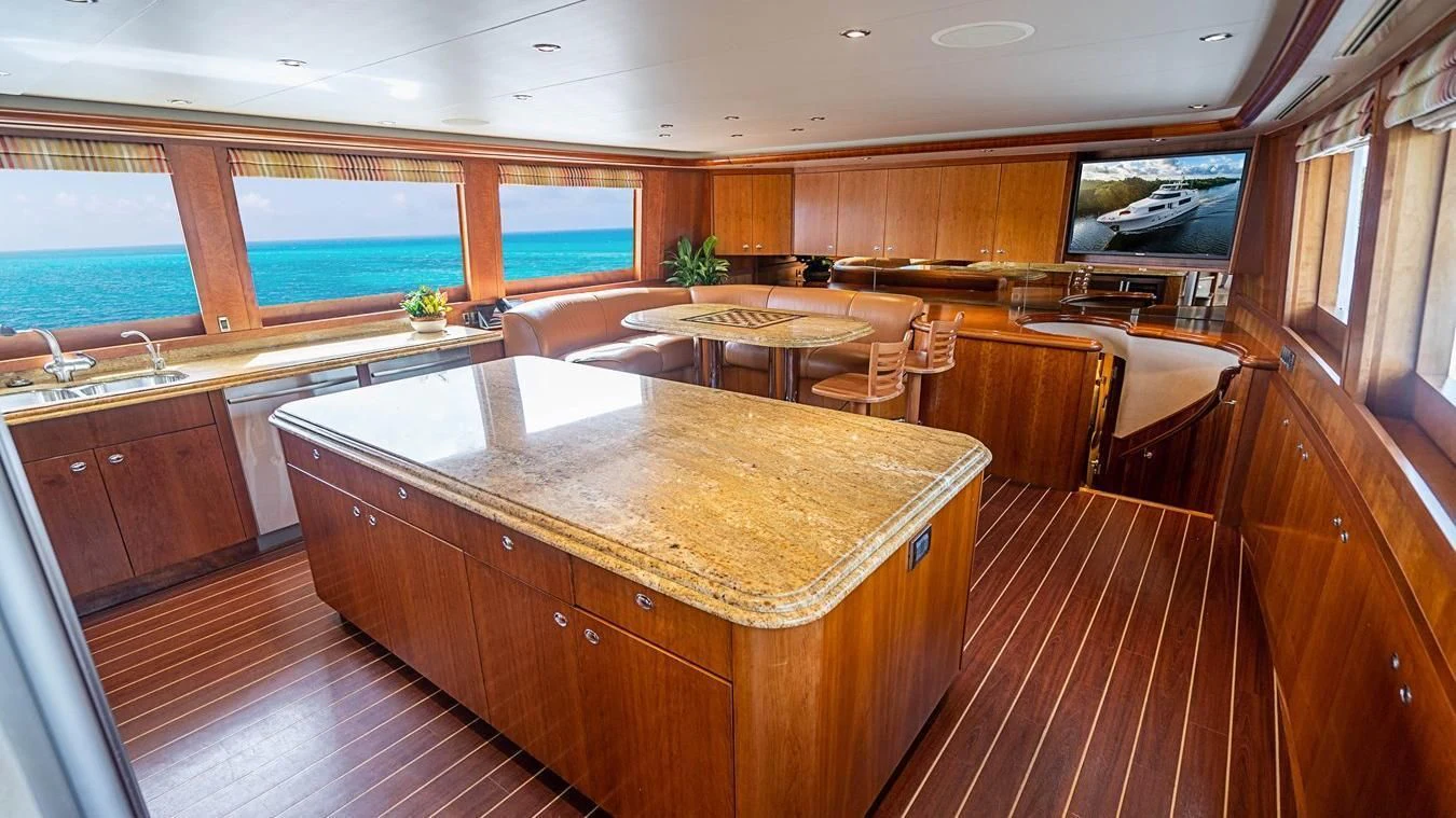a large kitchen with wooden cabinets aboard KEMOSABE Yacht for Charter