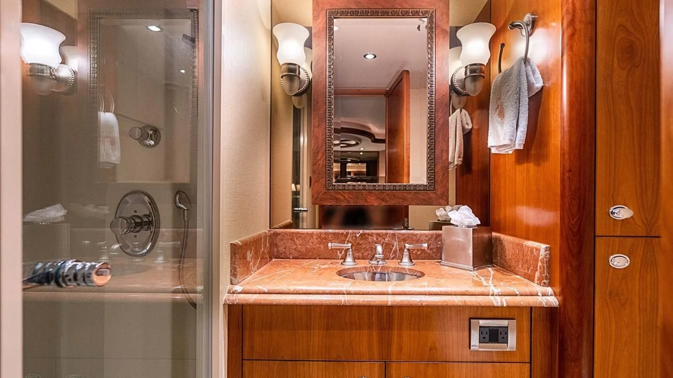 a bathroom with a sink and a mirror aboard KEMOSABE Yacht for Charter