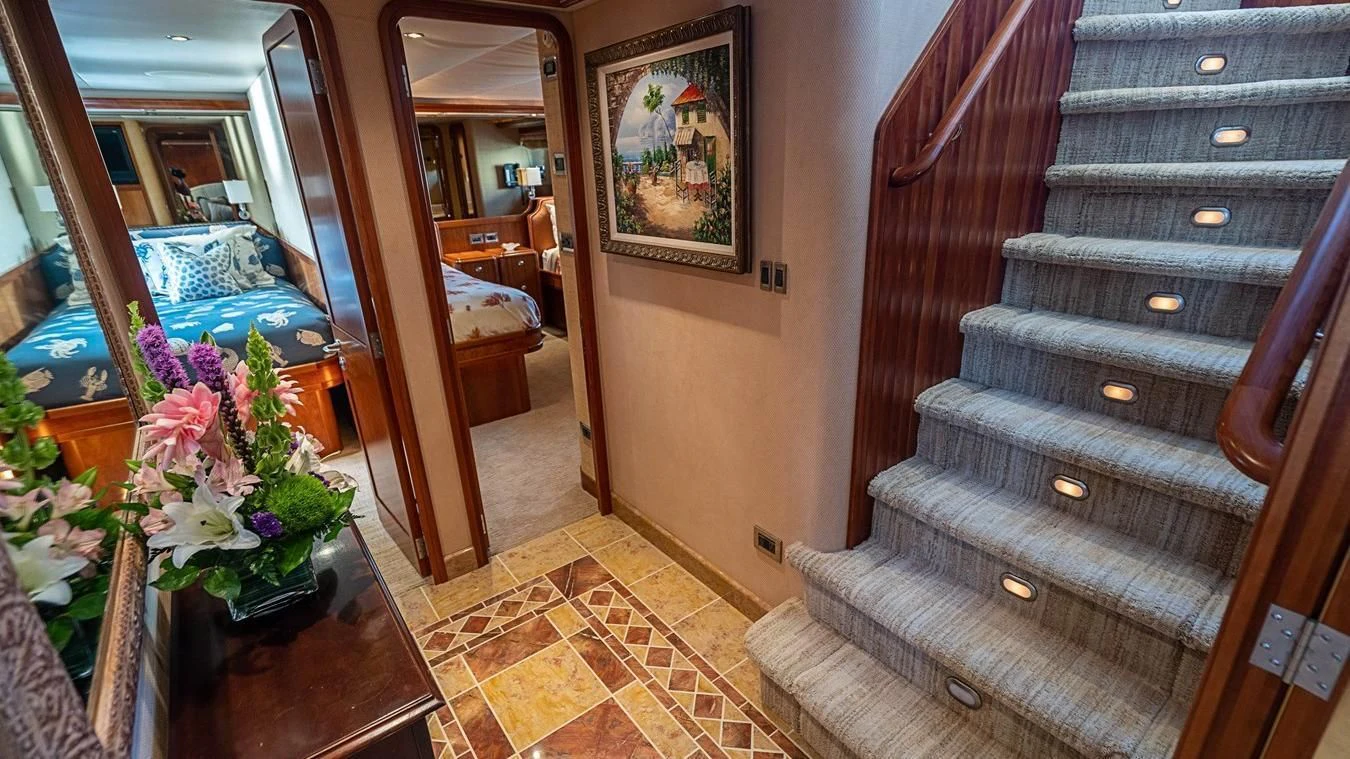 a room with a bed and a table aboard KEMOSABE Yacht for Charter