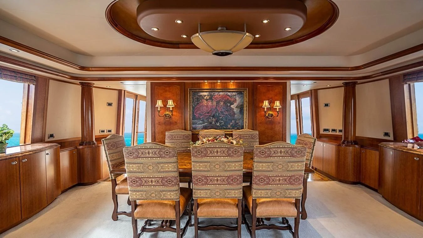 a large dining room with a chandelier aboard KEMOSABE Yacht for Charter