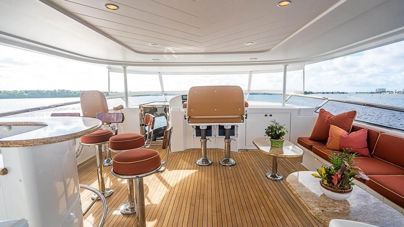 a room with a table chairs and a plant on the table aboard KEMOSABE Yacht for Charter