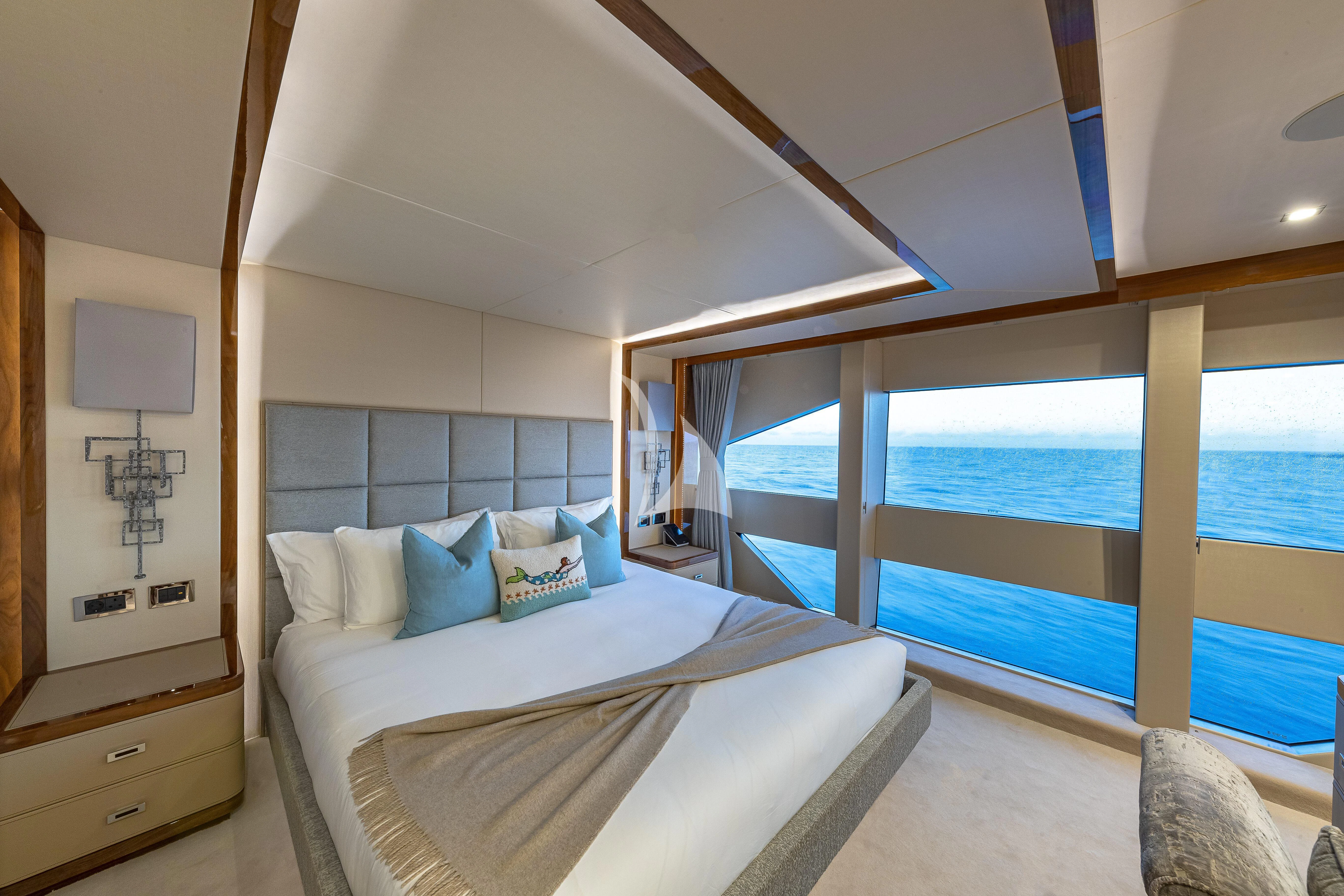 a room with a bed and a large window aboard ALESSANDRA III Yacht for Charter
