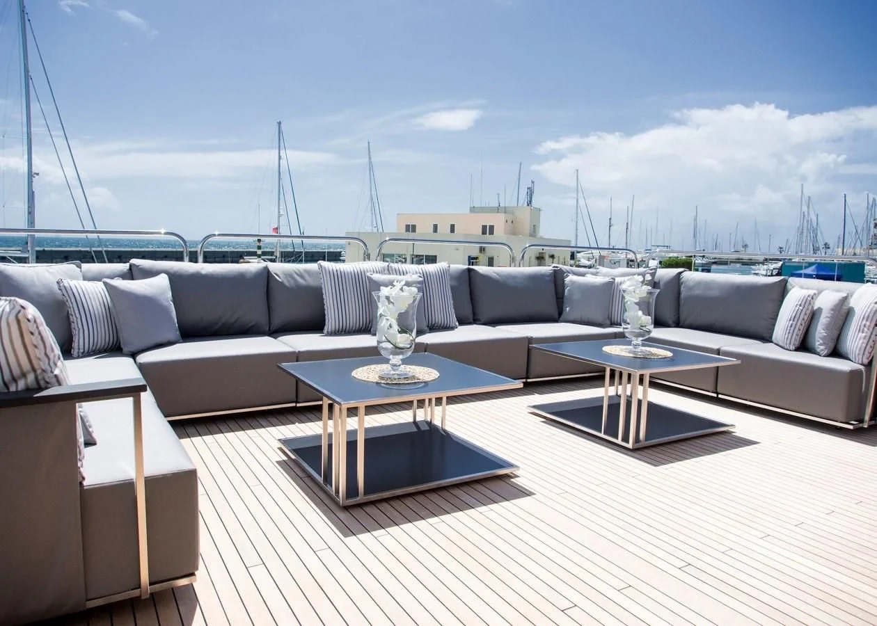 a living room with a couch and a table aboard ALESSANDRA III Yacht for Charter