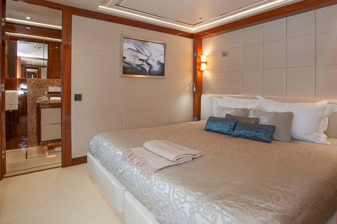 a bed with a white sheet and pillows on it aboard ALESSANDRA III Yacht for Charter