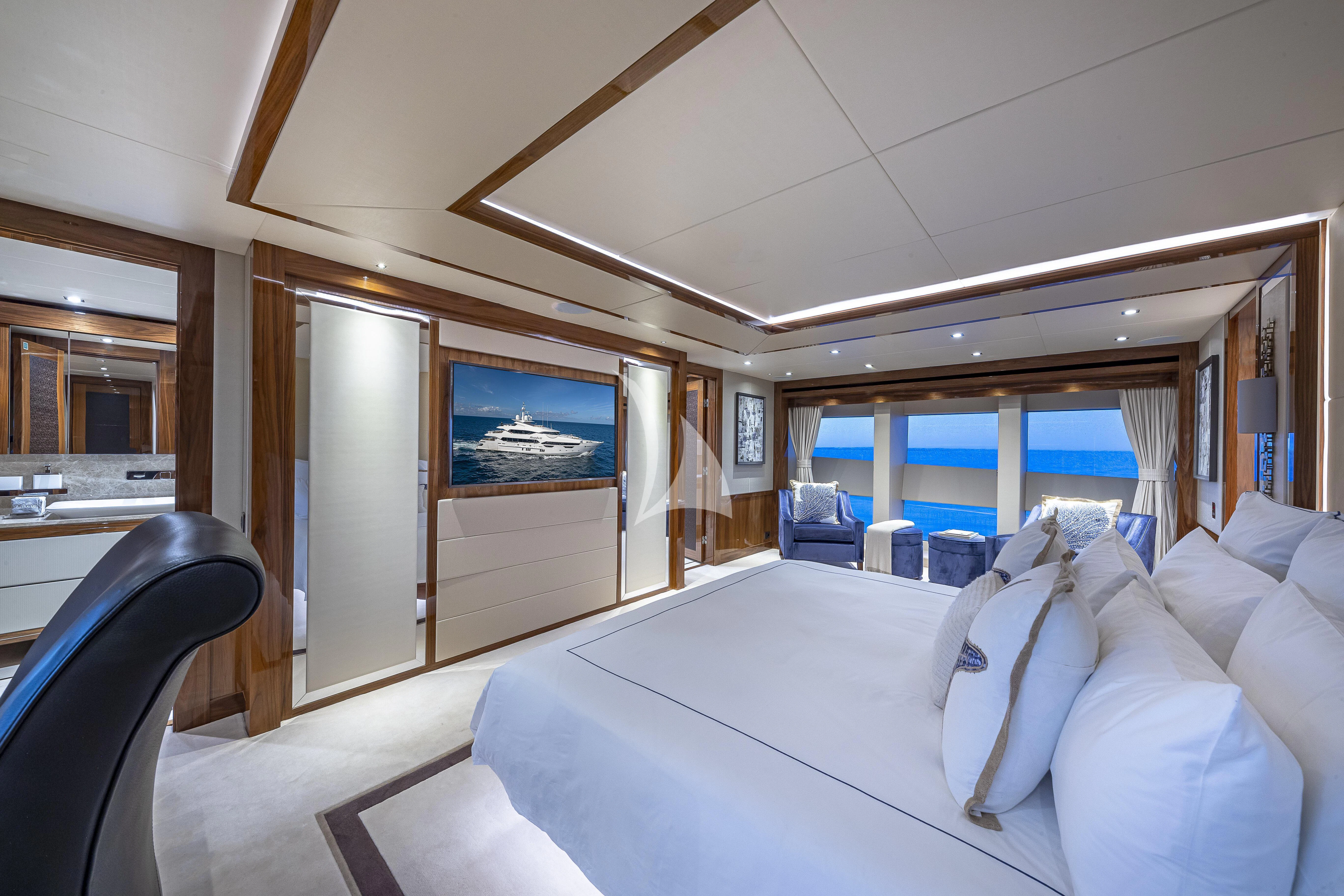 a room with a bed and a television aboard ALESSANDRA III Yacht for Charter