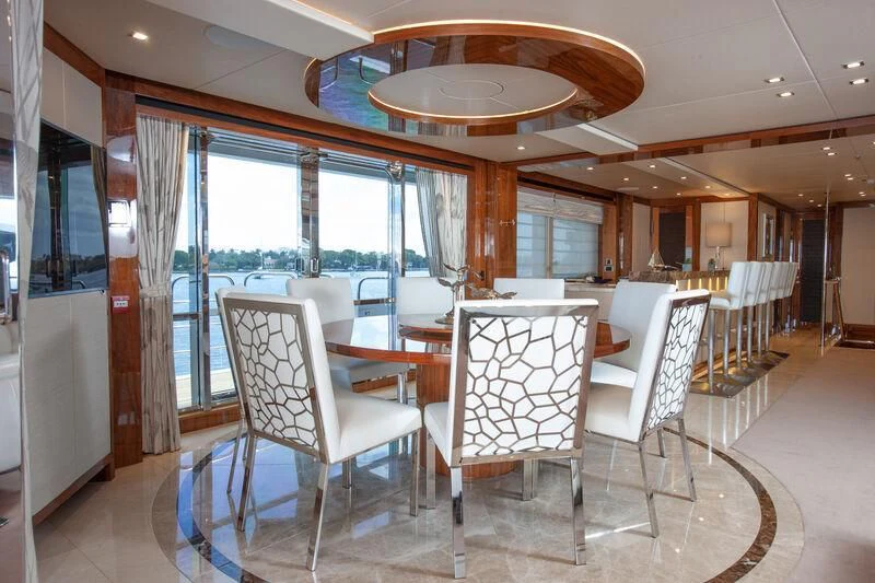 a room with a table chairs and a large window aboard ALESSANDRA III Yacht for Charter