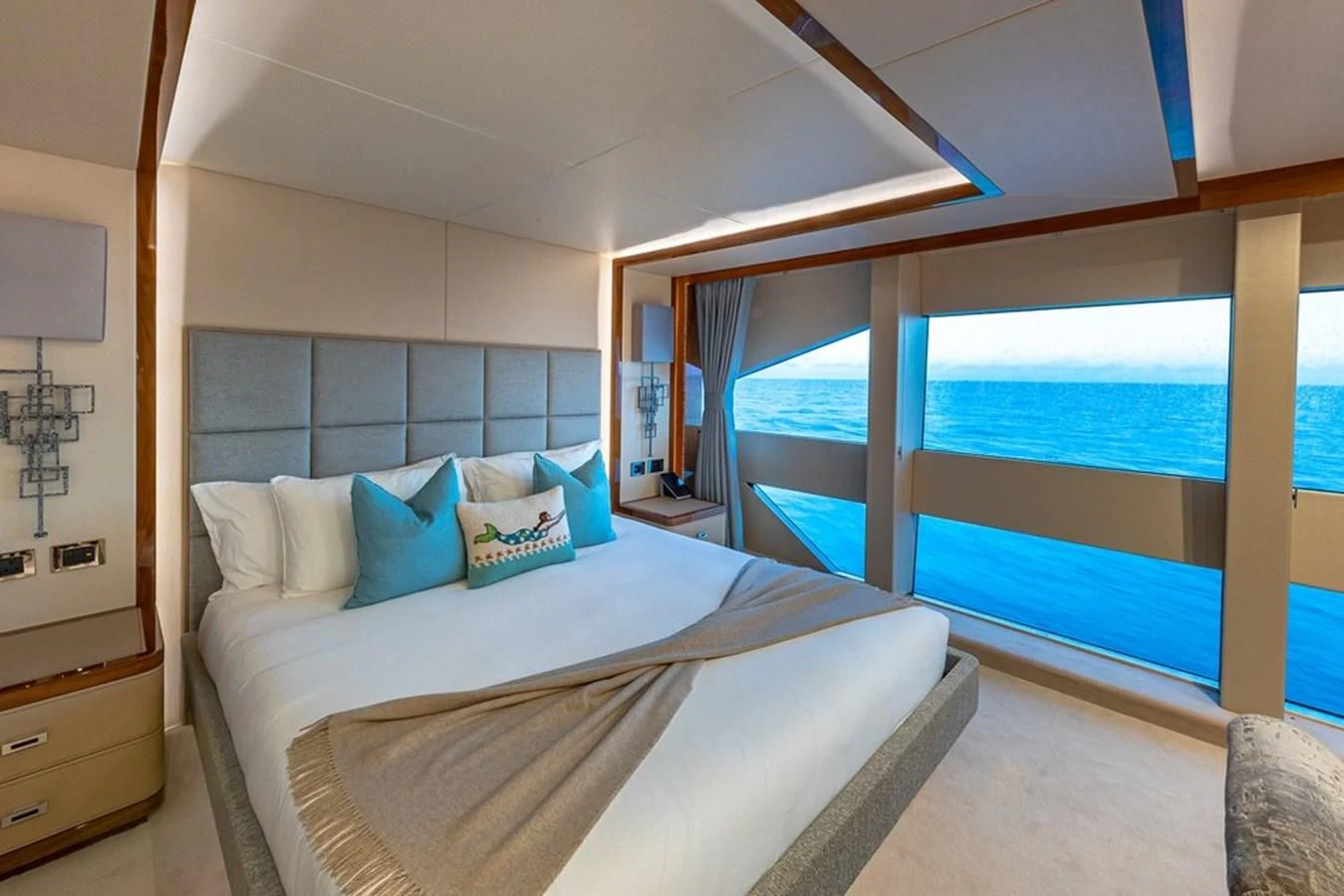 a bed with a large window aboard ALESSANDRA III Yacht for Charter