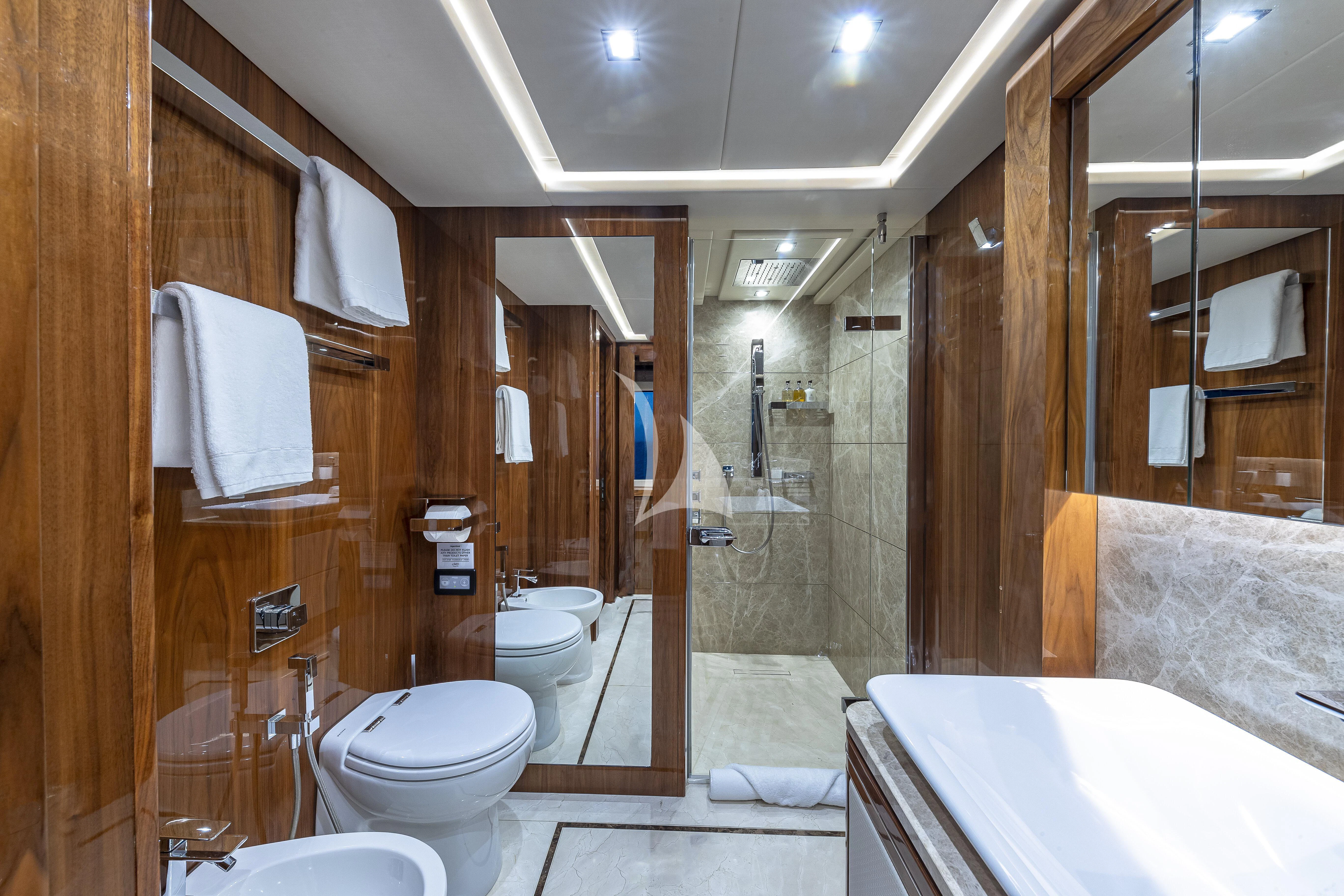 a bathroom with a tub toilet and sink aboard ALESSANDRA III Yacht for Charter