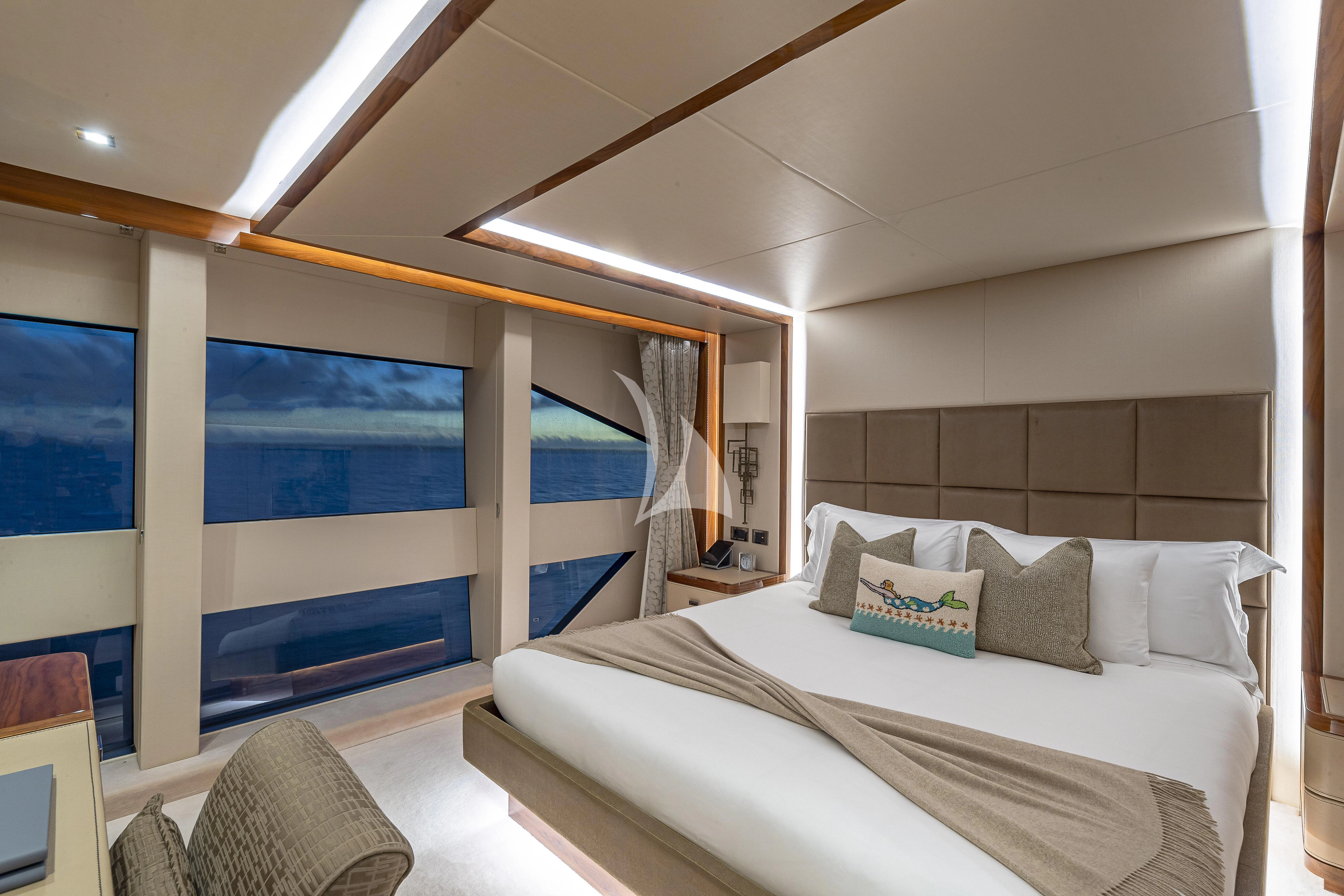 a room with a bed and a large window aboard ALESSANDRA III Yacht for Charter