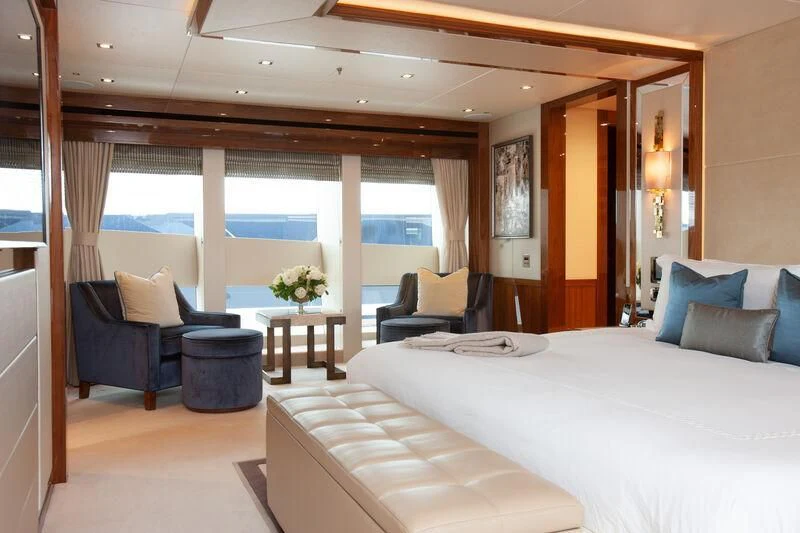 a room with a bed and a couch aboard ALESSANDRA III Yacht for Charter