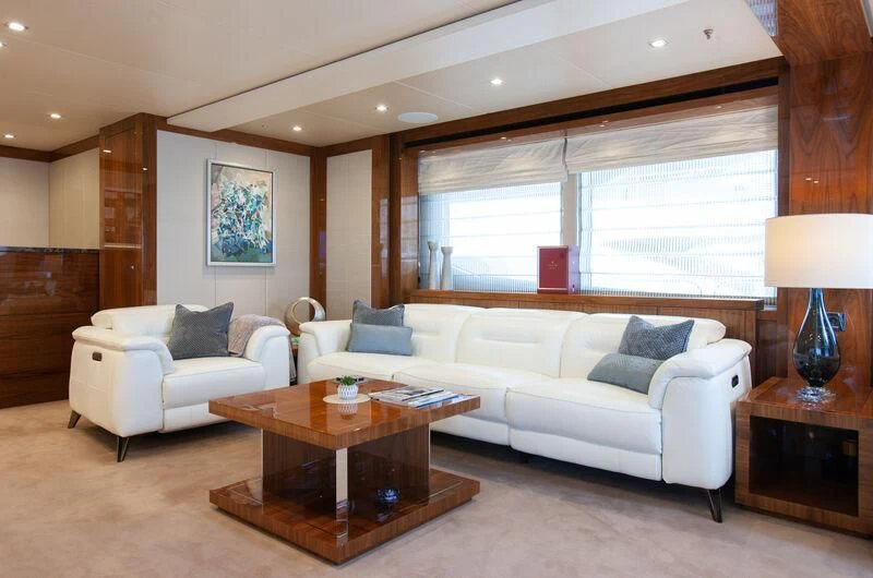 a living room with a white couch and a coffee table aboard ALESSANDRA III Yacht for Charter