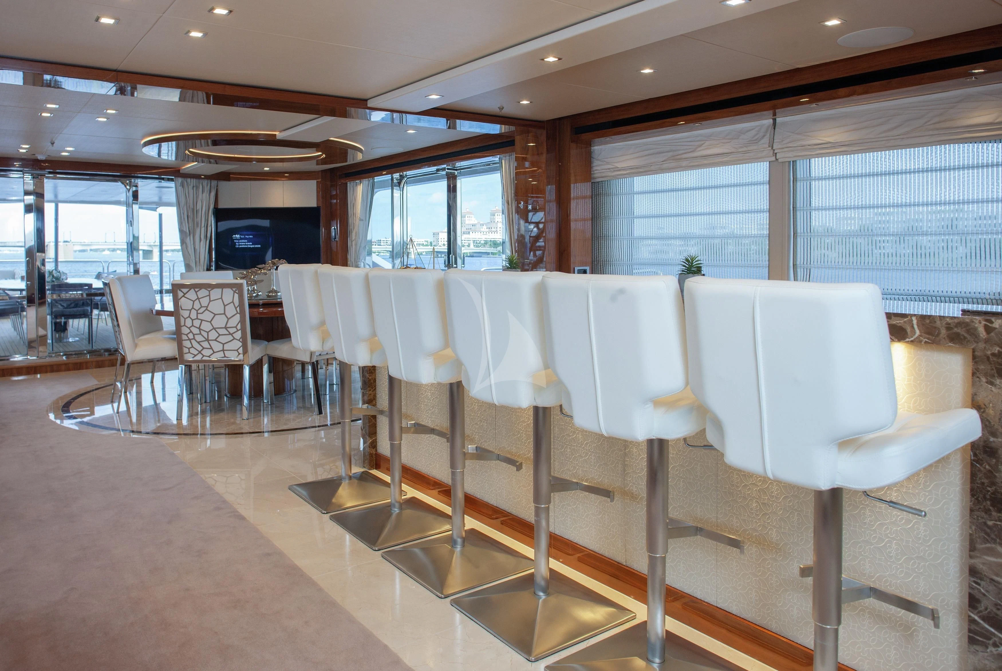 a room with tables and chairs aboard ALESSANDRA III Yacht for Charter