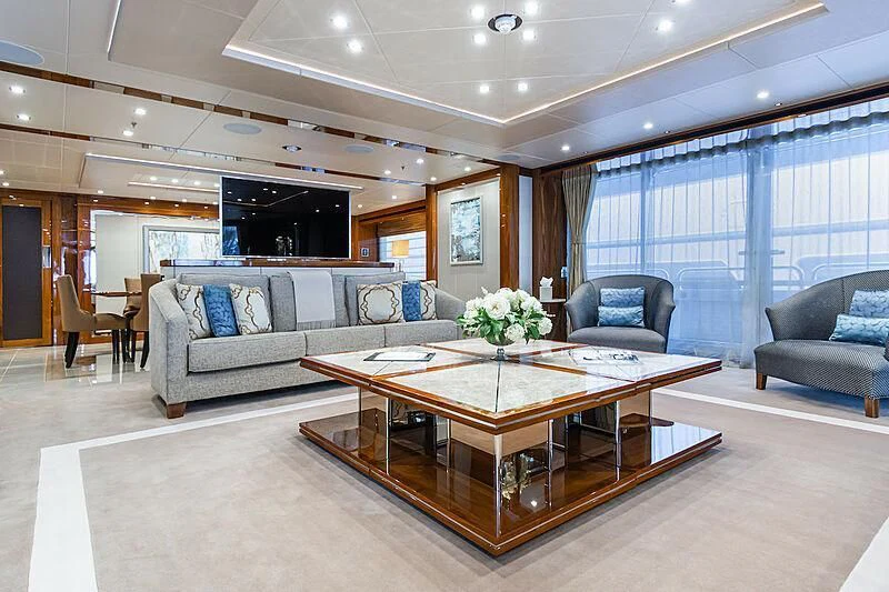 a living room with a large table and couches aboard ALESSANDRA III Yacht for Charter