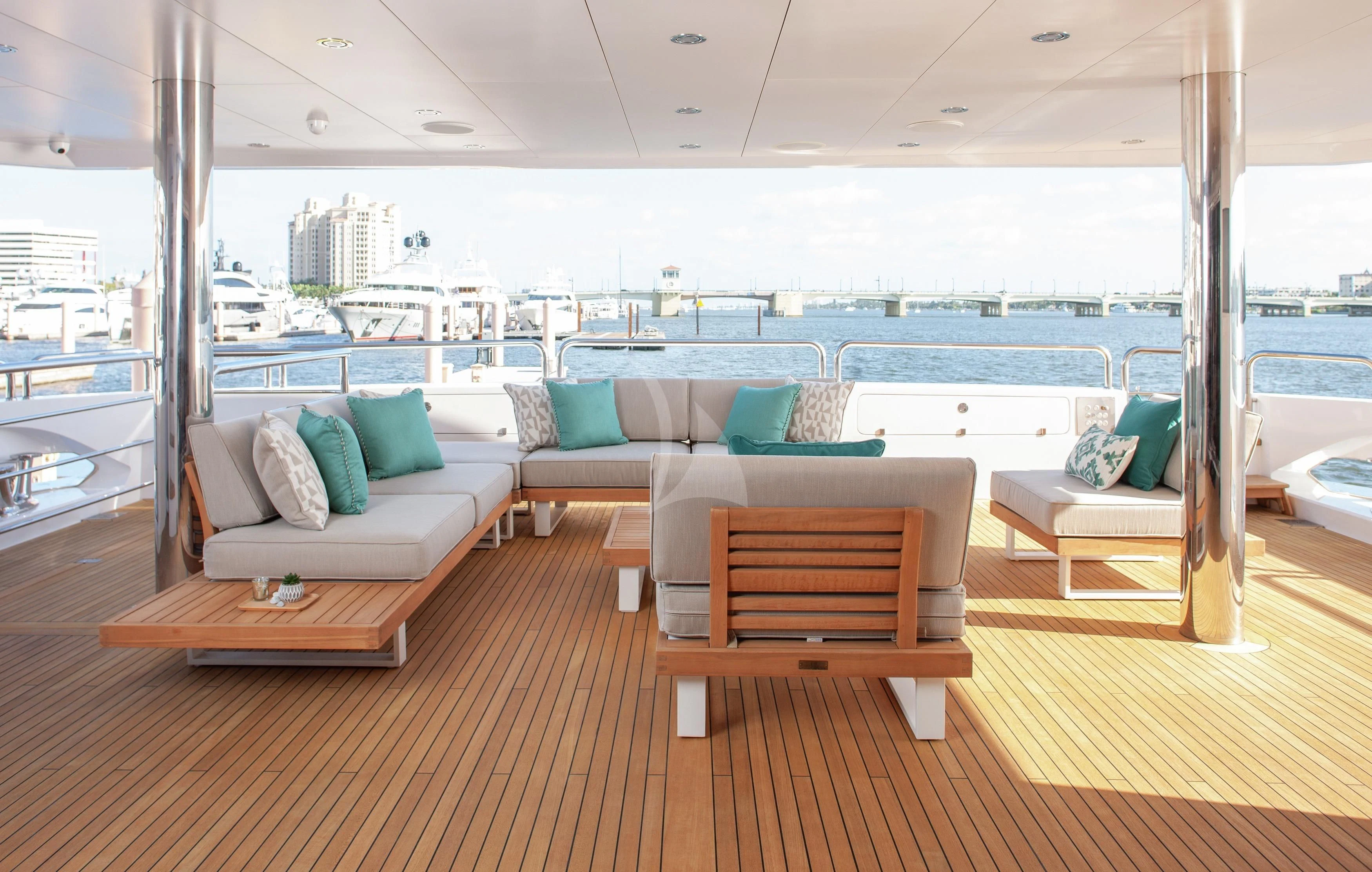a room with a couch and a table and a view of the water aboard ALESSANDRA III Yacht for Charter