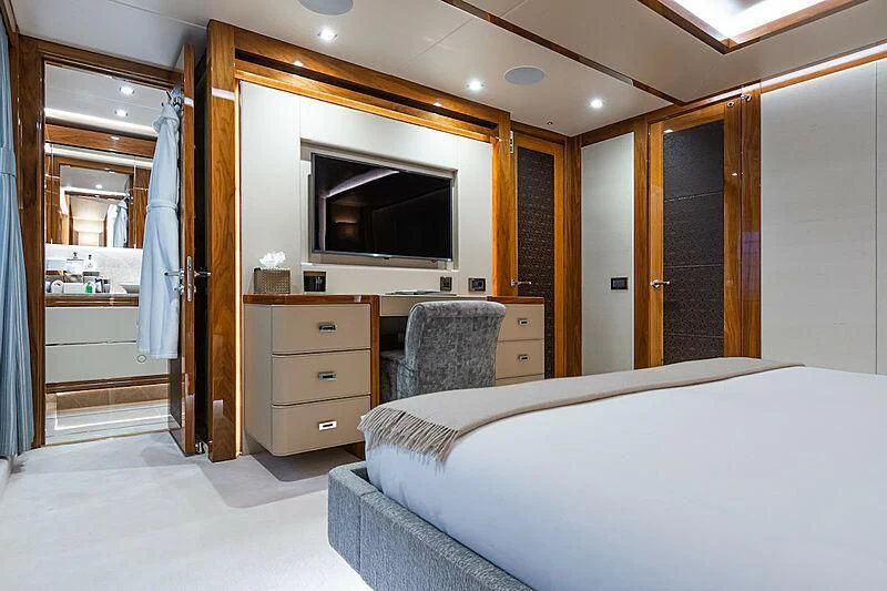 a bedroom with a bed and a television aboard ALESSANDRA III Yacht for Charter