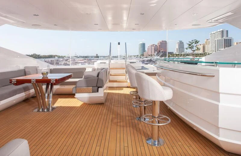 a room with a table chairs and a view of a city aboard ALESSANDRA III Yacht for Charter