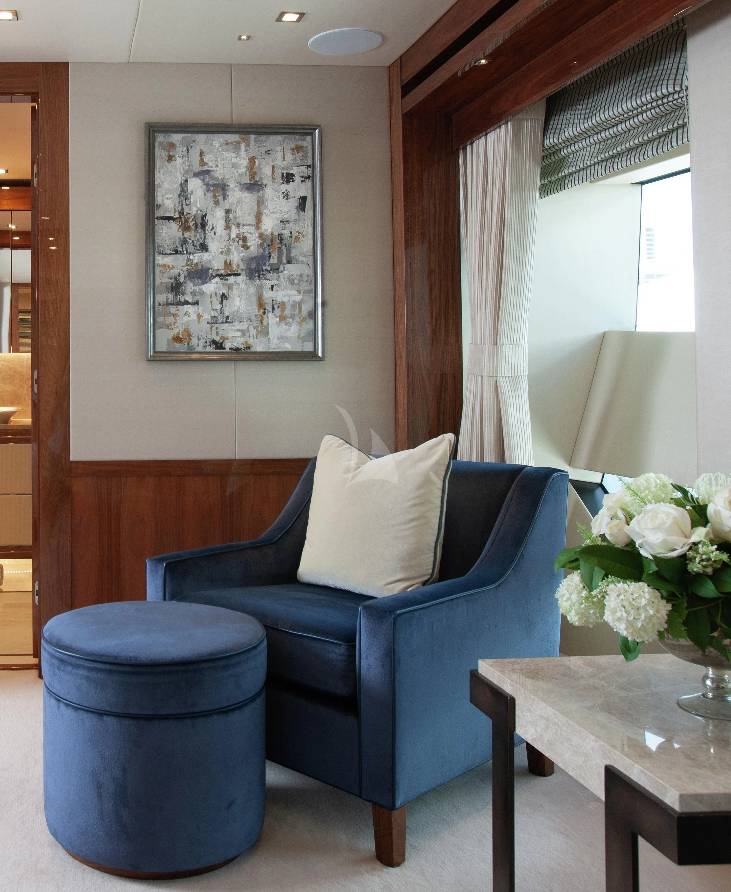 a blue chair in a room aboard ALESSANDRA III Yacht for Charter