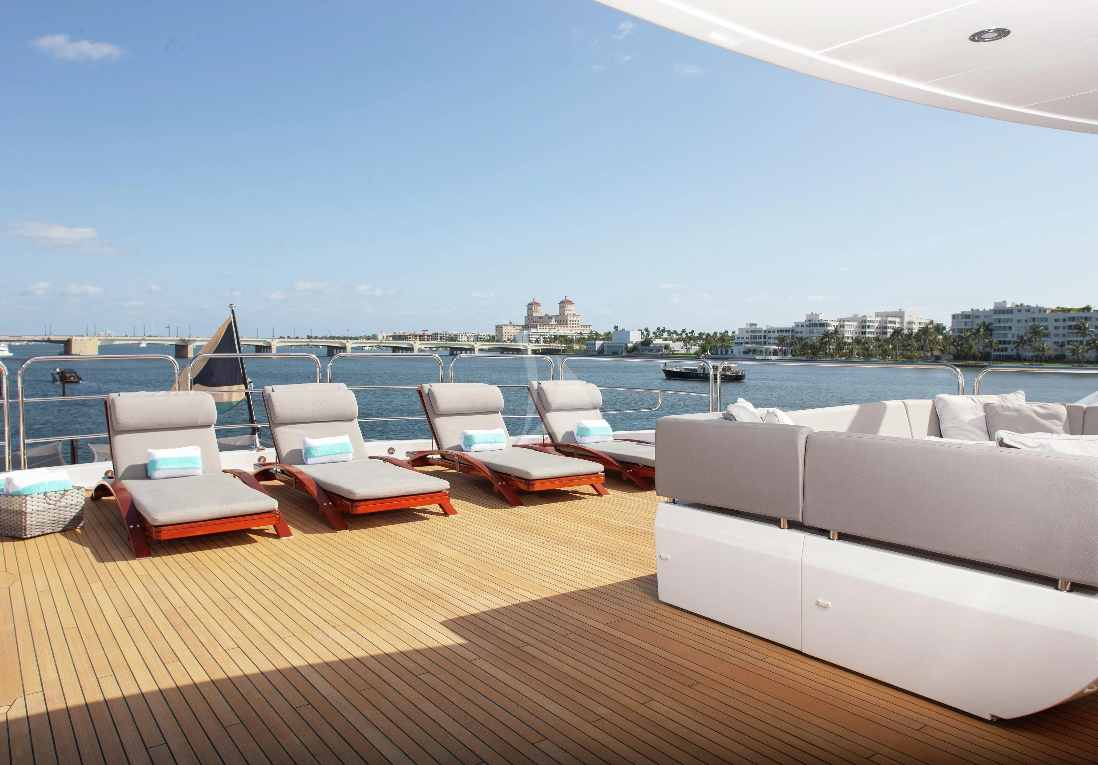 a deck with a view of a city and a large body of water aboard ALESSANDRA III Yacht for Charter