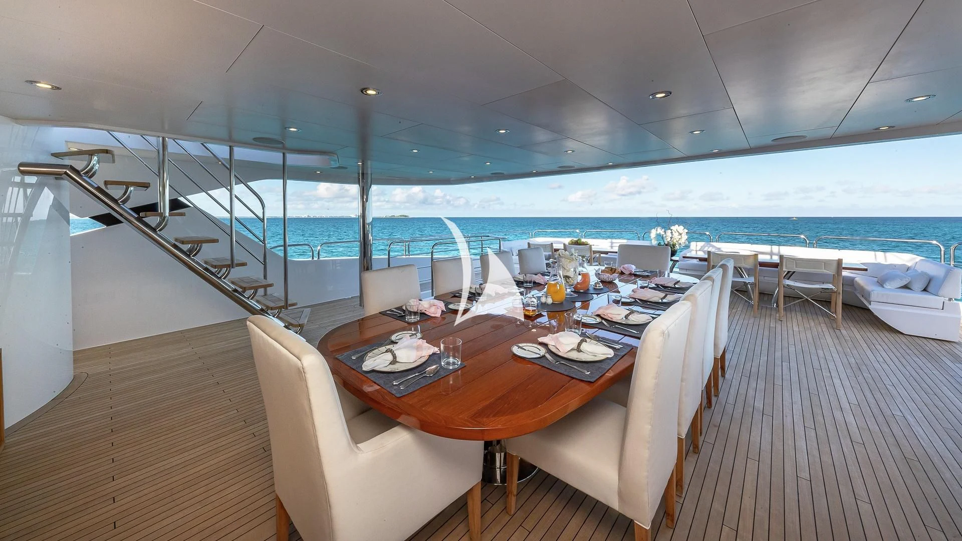 a table with plates and chairs on it aboard ALESSANDRA III Yacht for Charter