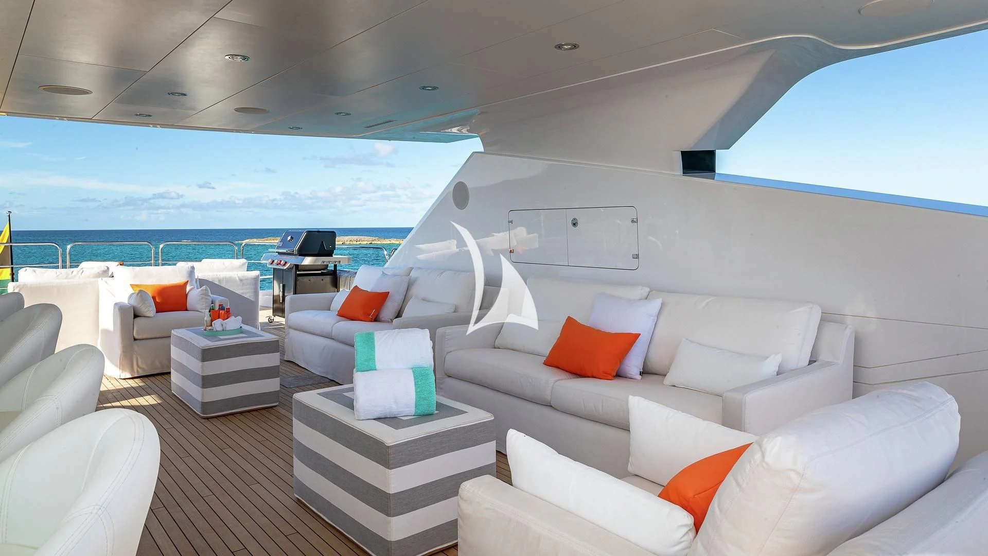 a white living room with a large window overlooking the ocean aboard ALESSANDRA III Yacht for Charter