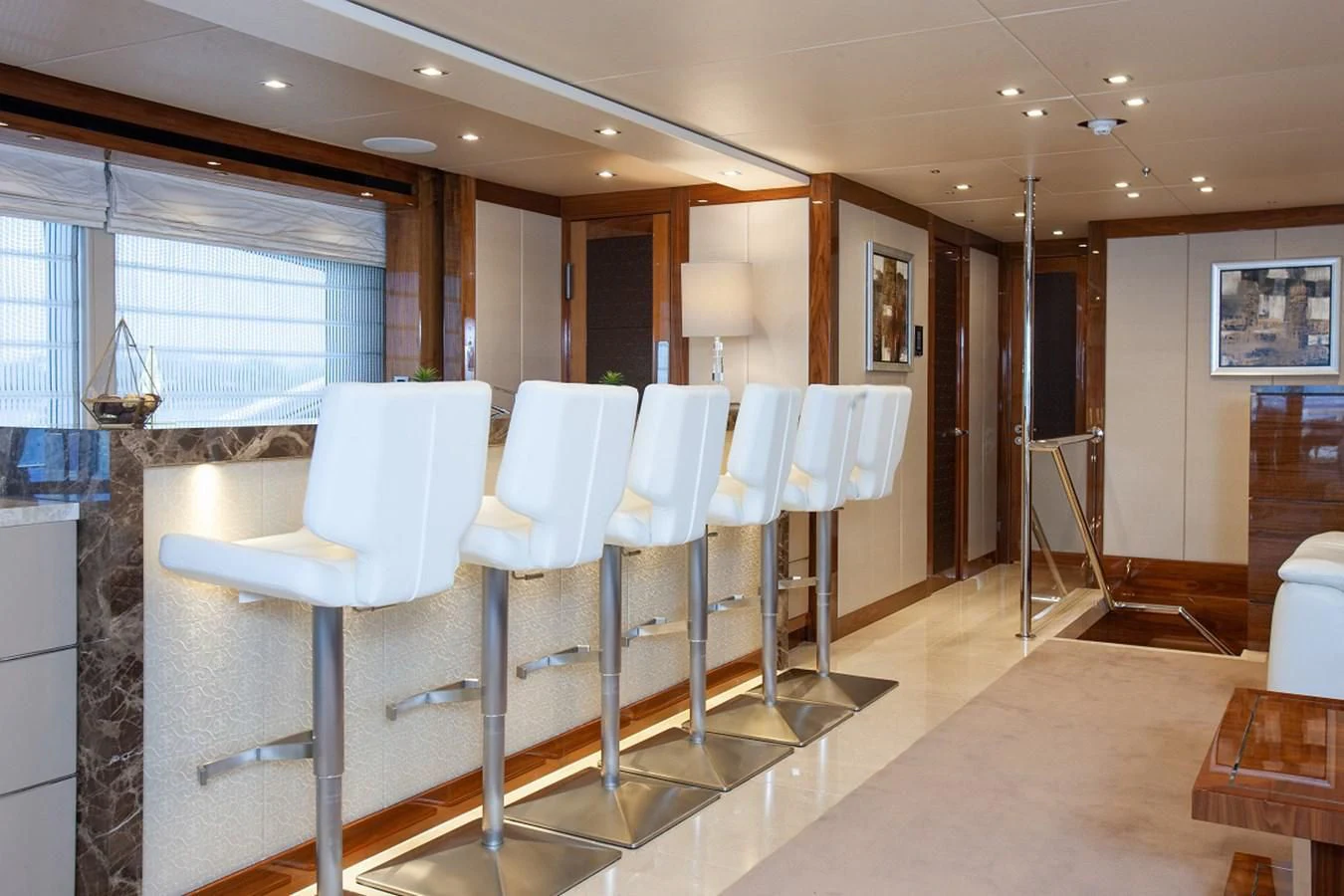 a room with chairs and tables aboard ALESSANDRA III Yacht for Charter