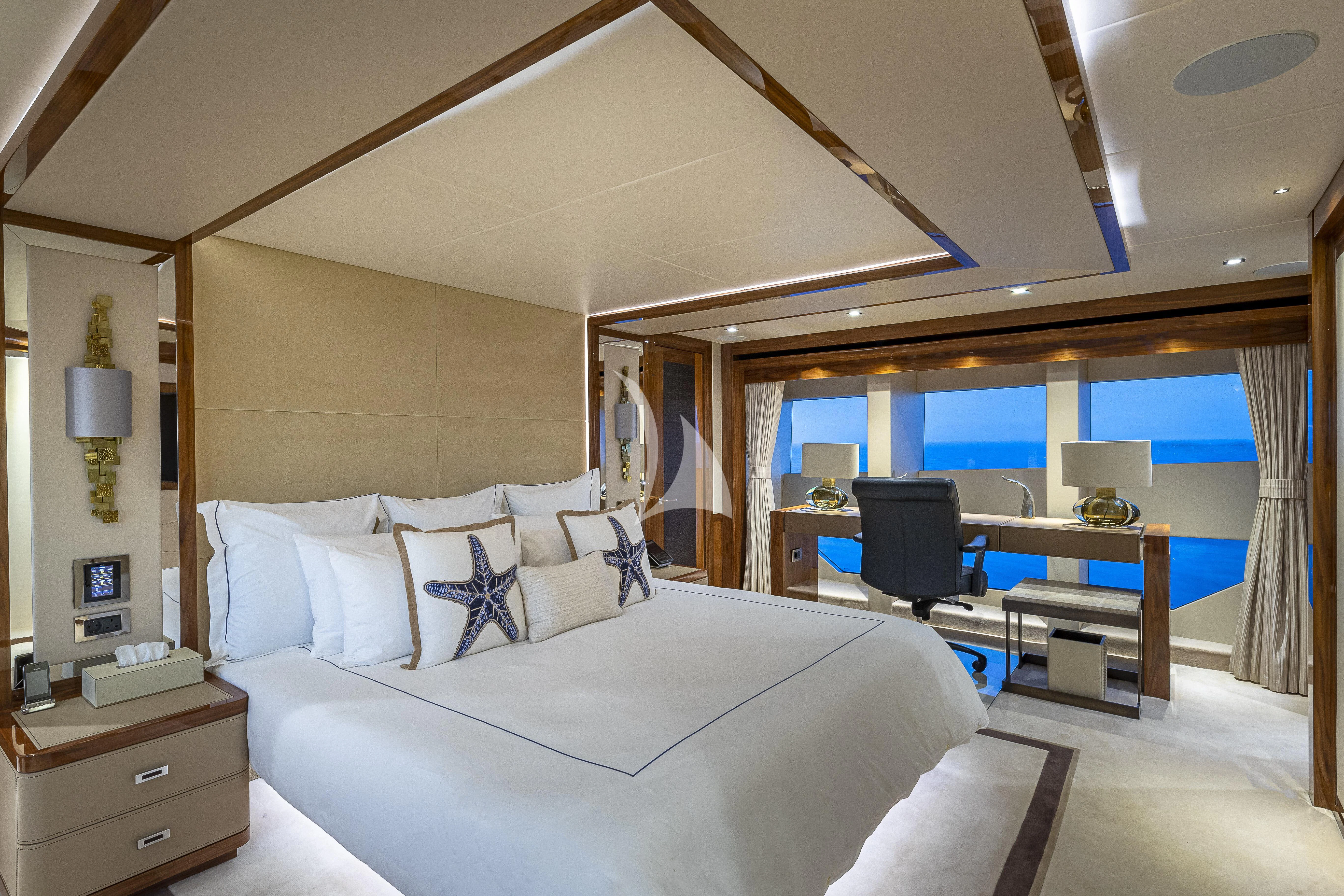 a hotel room with a bed and desk aboard ALESSANDRA III Yacht for Charter