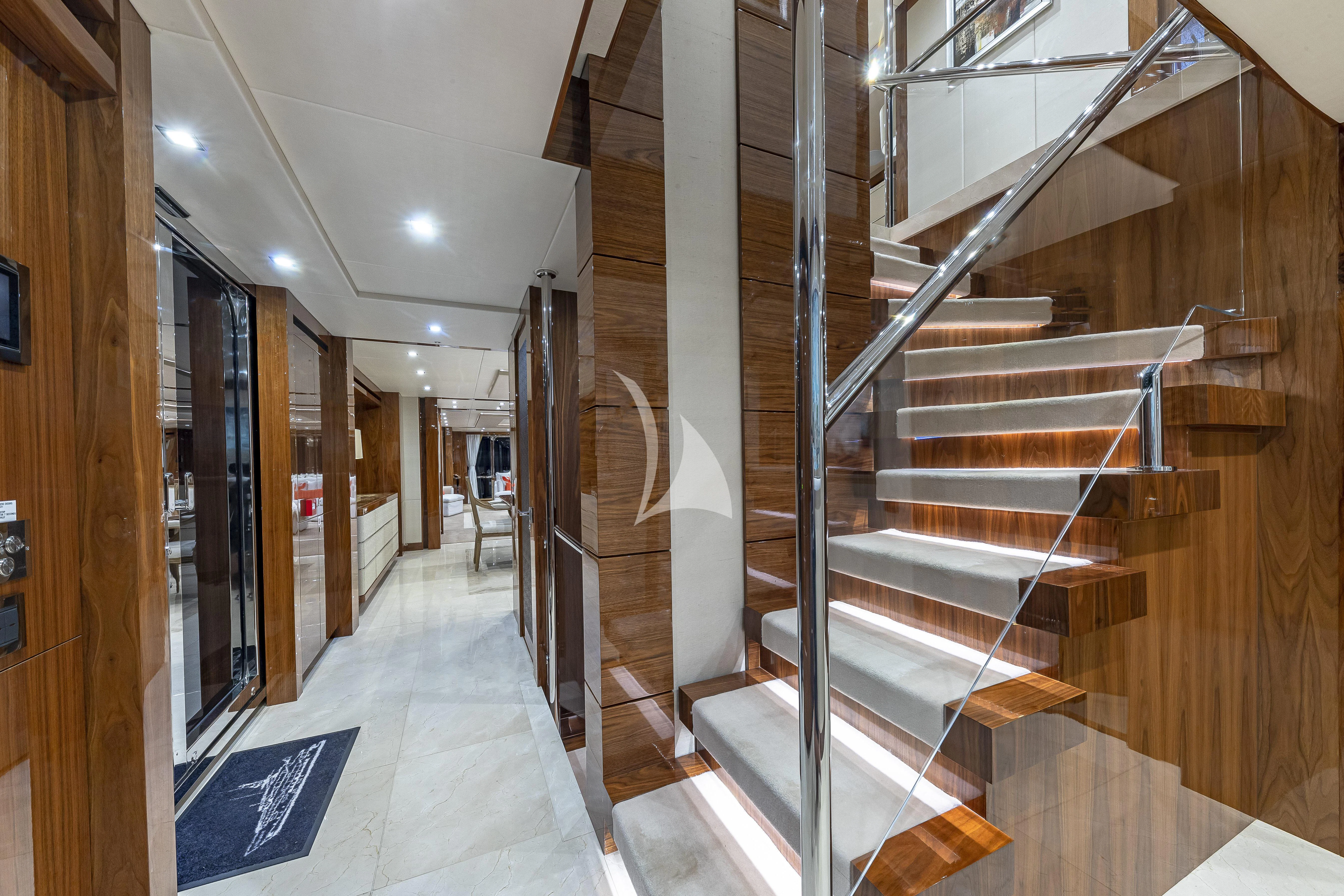 a room with wooden stairs aboard ALESSANDRA III Yacht for Charter
