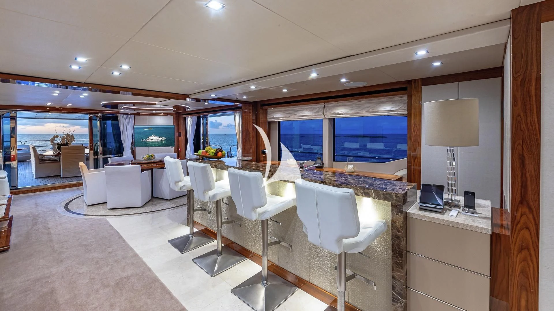 a room with tables and chairs aboard ALESSANDRA III Yacht for Charter